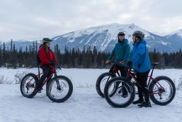 Group having fun on a fat bike tour in the snow during winter Jasper national park.