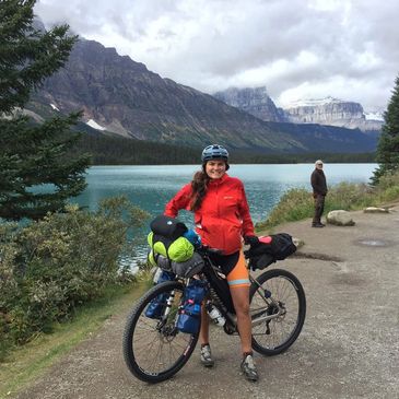 woman bike packing the icefields parkway between banff and jasper