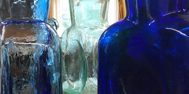 An assortment of Blenko water bottles