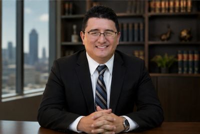 Professional man in a suit sitting at a desk.