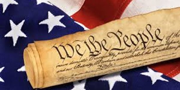 The U.S. Constitution scroll on an American flag.