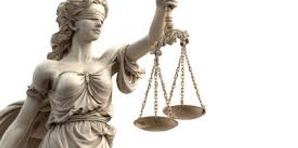 Statue of Lady Justice holding scales, symbolizing fairness and law.