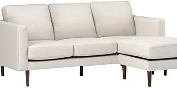 White modern sectional sofa with chaise and wooden legs.