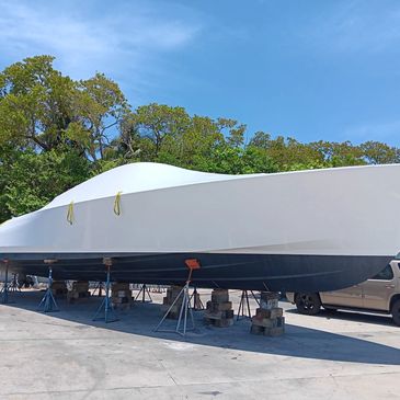Boat dry docked on stands for maintenance.
