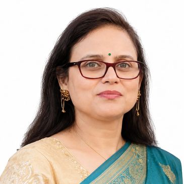 Woman wearing glasses and a bindi in a saree.