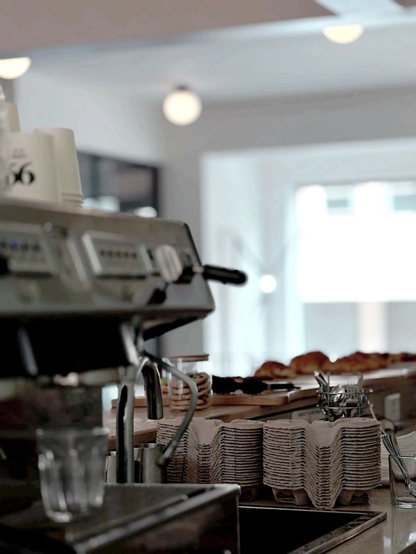 Coffee machine and coffee cup holders on a cozy cafe counter.