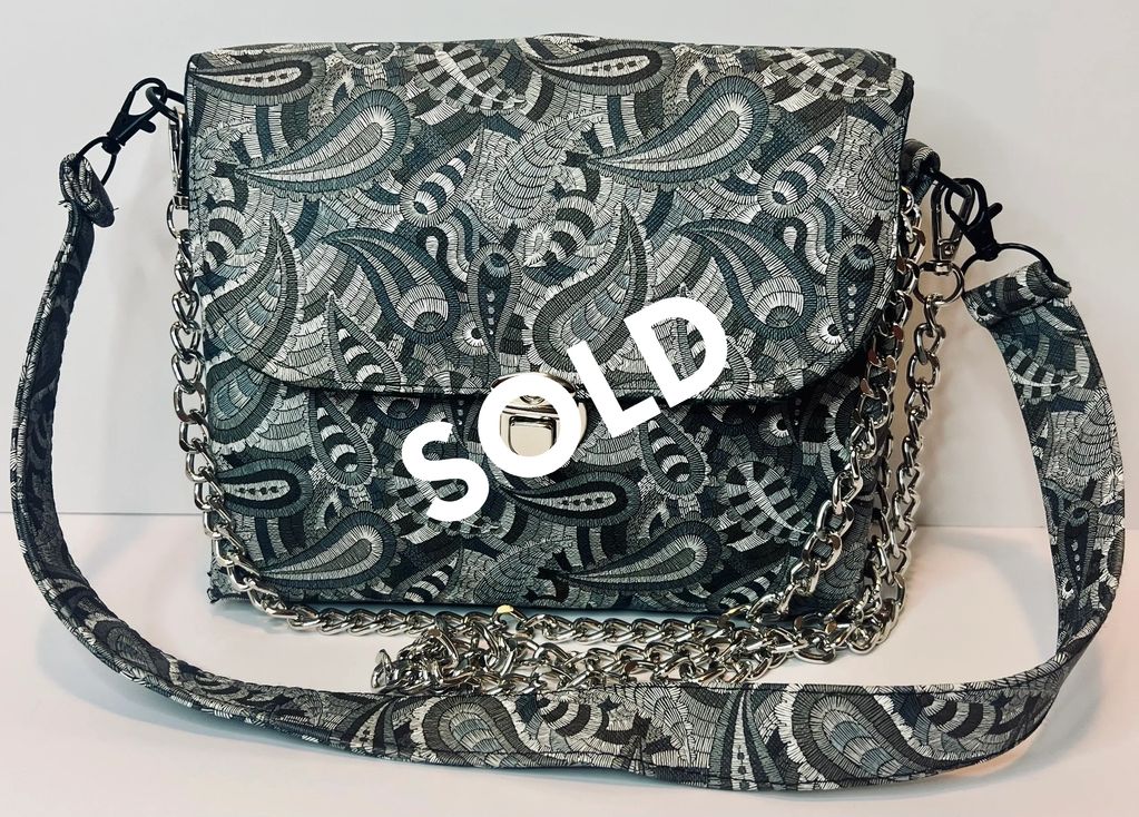 Faux leather paisley printed purse with matching strap and included silver strap $150.00