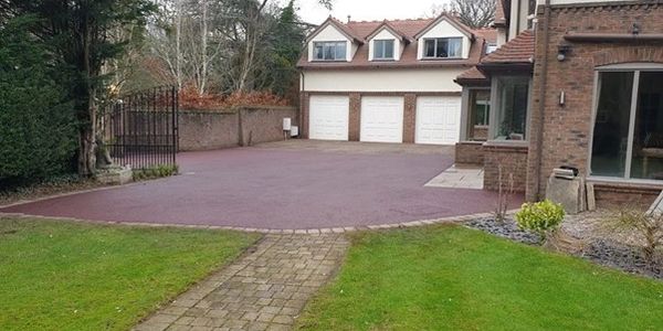 Red tarmac drive finished with grey block edgings