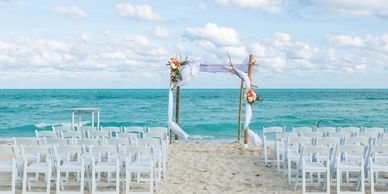Wedding setting at the beach with white chairs waiting for Bride and Groom in Florida