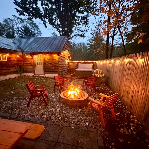 View of private courtyard at Troy's Cabin with the fire pit, and ambiance from the string lights.