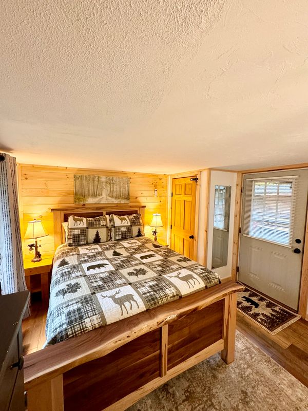 Queen Bedroom of Troy's Cabin with access to the private courtyard.
