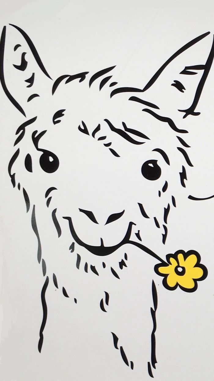 an alpaca with a flower in its mouth.