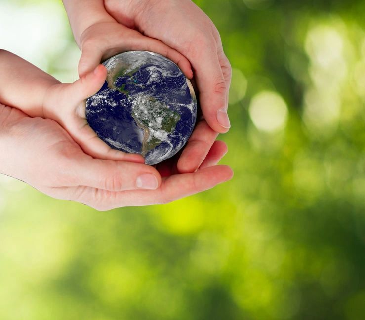 Earth held in child and adult's hand