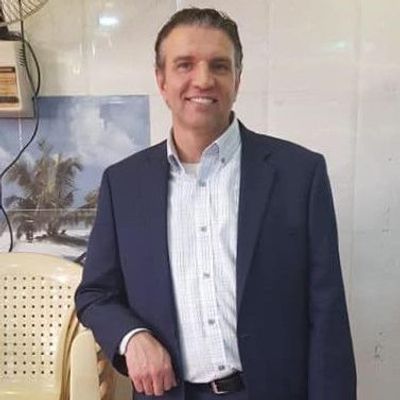 A handsome man named Dean Shoesmith standing in a suit