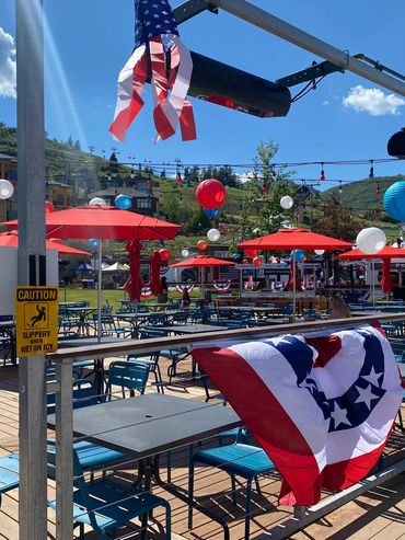 Outdoor seating area decorated with red, white, and blue for a patriotic event.