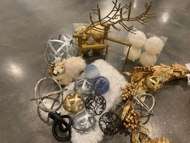 Decorative holiday ornaments and a faux squirrel on a gray surface.