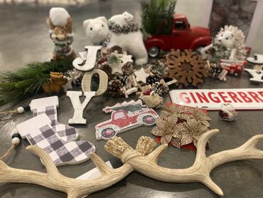 Festive Christmas decorations including wooden letters, a red truck, and animal figurines.