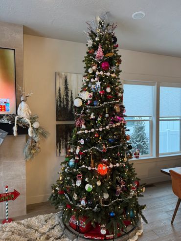 A tall, decorated Christmas tree with various ornaments and lights.