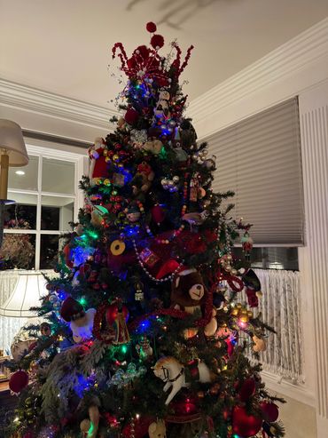 A beautifully decorated Christmas tree with colorful lights and various ornaments.