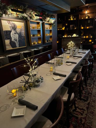 Elegant dining table with festive decorations and warm candlelight.