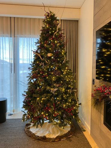 A beautifully decorated Christmas tree with warm lights and natural ornaments.