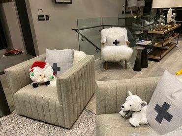 Cozy living room with plush chairs and festive stuffed toys.