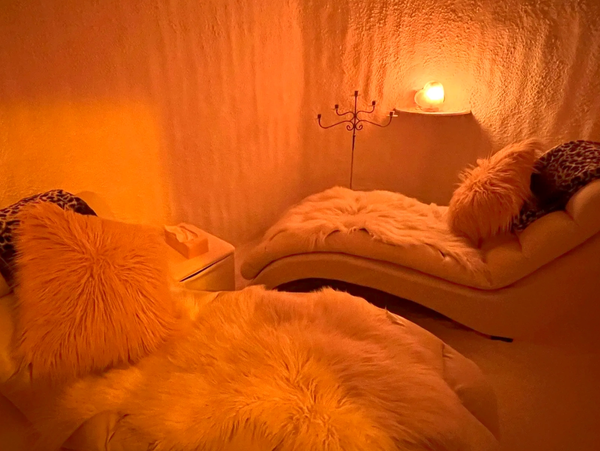 Cozy room with soft lighting and plush cushions.