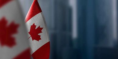 A close-up of the Canadian flag with a blurred background.