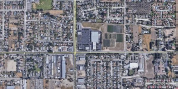 Aerial view of an urban neighborhood with roads and buildings.