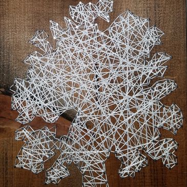 string art with strings on inside of tree figure