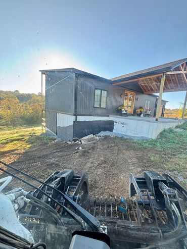 Backfilling around a house.