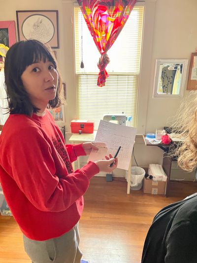 Erica Qualy holds her plans for an artistic project. Photo by Aaron Brame.