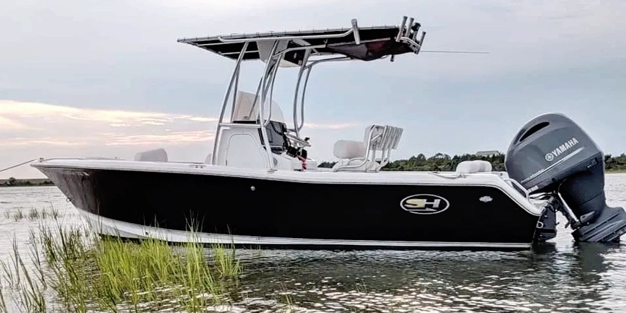 The Black Boat, a center console Sea Hunt, anchored on the creek.