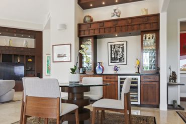 Modern dining area with wooden furniture and decorative vases.