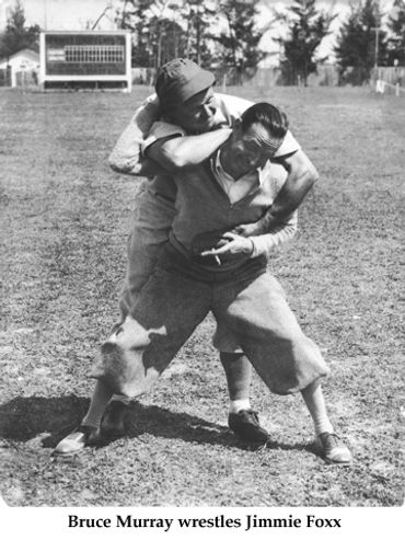 Baseball legend Jimmie Foxx wrestling with photographer Bruce Murray in Ft.Myers FL spring training
