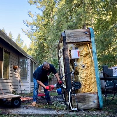 Team member cutting and demoing jacuzzi for removal in 93510 93543 93550  by Family Junk Removal