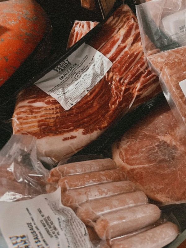 Various packaged meats including bacon and sausage.