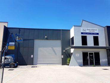 Industrial building exterior repaint in Dandenong with grey façade