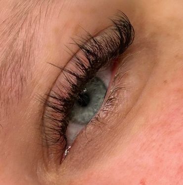 Close-up of an eye with long, dark eyelashes.