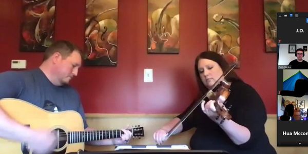 Andy and Emily playing a duo show on a Zoom meet during the Pandemic