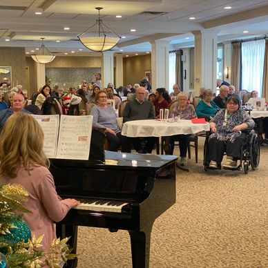 A little girl playing piano at a music recital