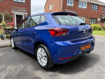 Blue SEAT Ibiza parked in a residential driveway.