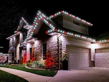 House decorated with Christmas lights at night.