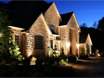Stone house illuminated at night.