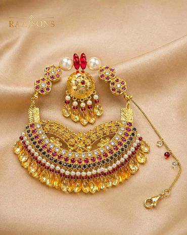 Intricately designed traditional gold jewelry with colorful gemstones and pearls.