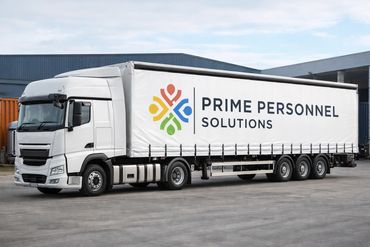 White truck with Prime Personnel Solutions logo parked outside a warehouse.