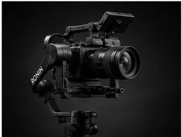 Professional camera mounted on a Ronin gimbal stabilizer against a black background.