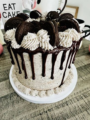 Cookies and cream cake with chocolate drip and Oreo decorations.