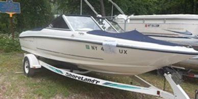 White motorboat on trailer outdoors.