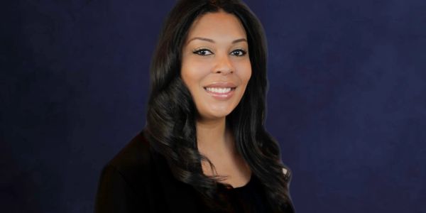 Portrait of a smiling woman with long black hair.